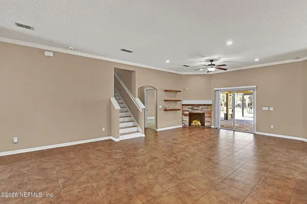 a view of a livingroom with a ceiling fan and window