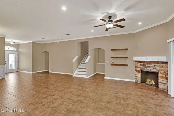 a view of an empty room with a fireplace