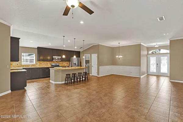 a view of kitchen with refrigerator and window
