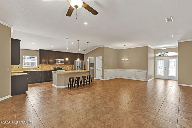 a view of kitchen with refrigerator and window