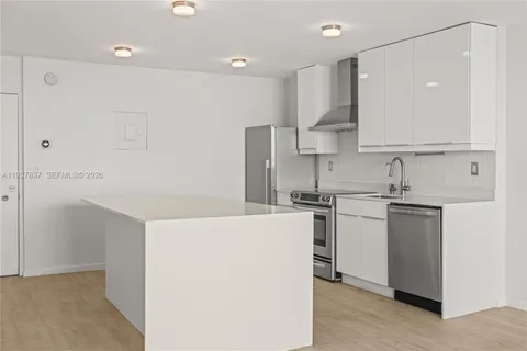 a kitchen with a sink a stove and refrigerator