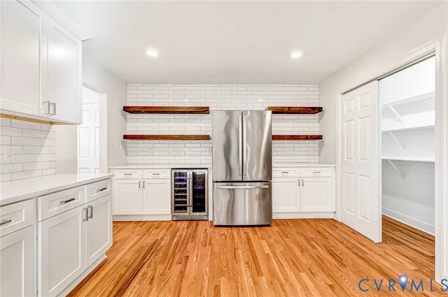 a kitchen with granite countertop a refrigerator stove top oven and sink