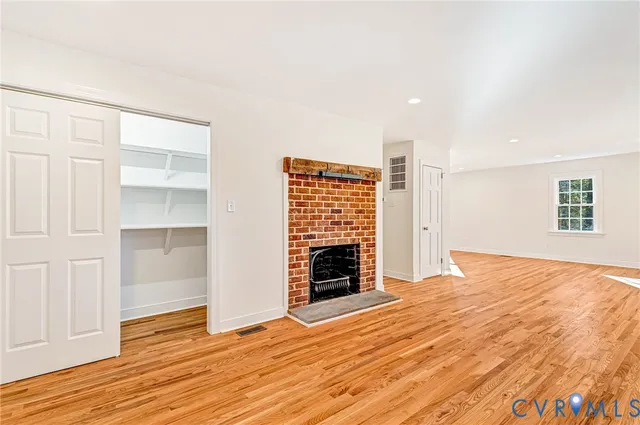 a kitchen with granite countertop wooden floors a stove and a sink