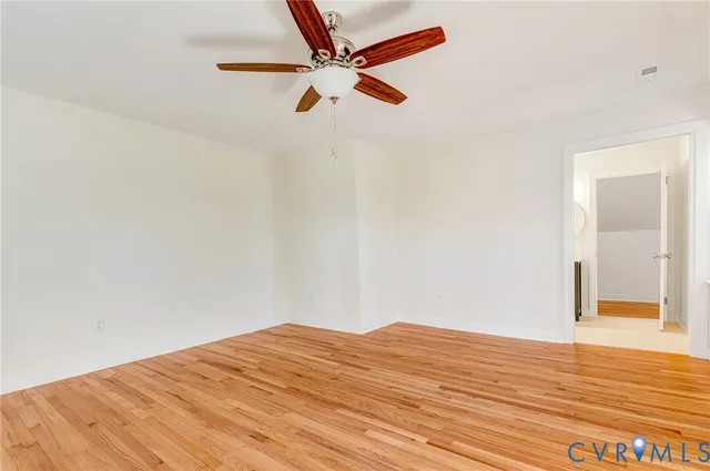 a bathroom with a toilet a double vanity sink and a mirror