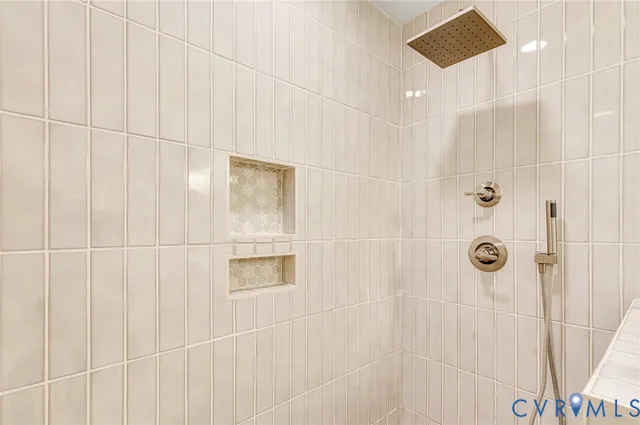 an empty room with wooden floor chandelier fan and windows