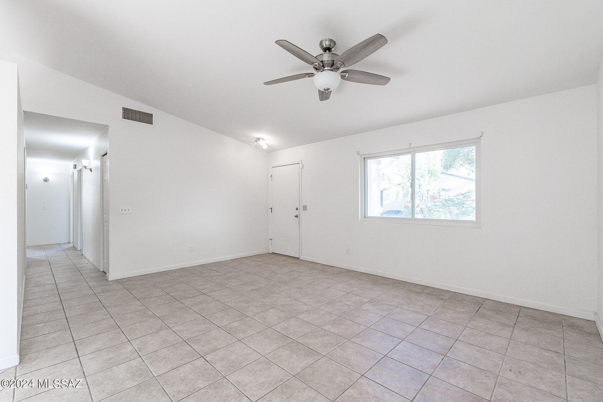 2690 West Sunset Road Tucson, AZ 85741 - Photo 10 of 33 a view of a big room with wooden floor and windows