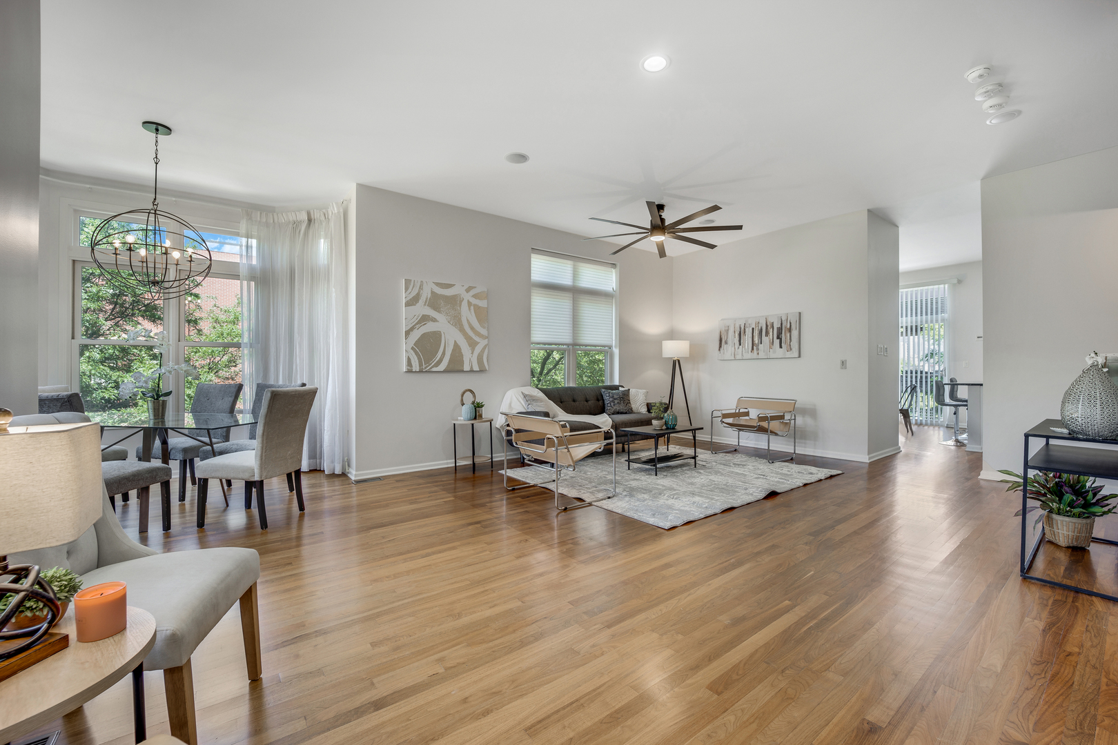 701 West 15th Street Chicago, IL 60607 - Photo 3 of 36 a view of a dining room and livingroom with furniture wooden floor a chandelier