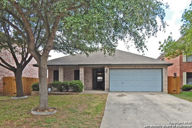 6315 Regency Crest San Antonio, TX 78249 - Photo 1 of 1 a front view of a house with a yard and garage
