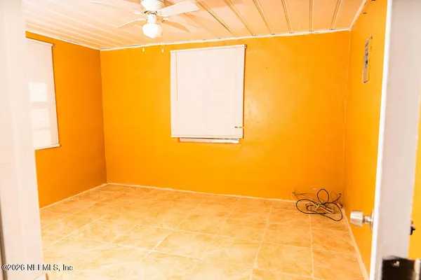 a view of a room that has a window and a door