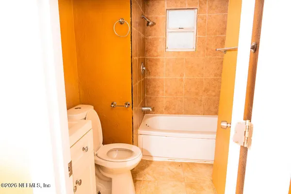 a bathroom with a toilet and shower