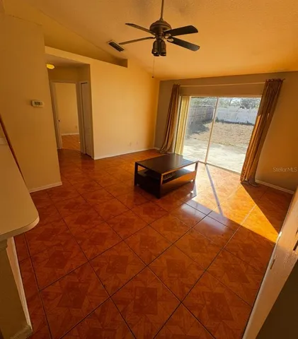 a view of a room with wooden floor and windows