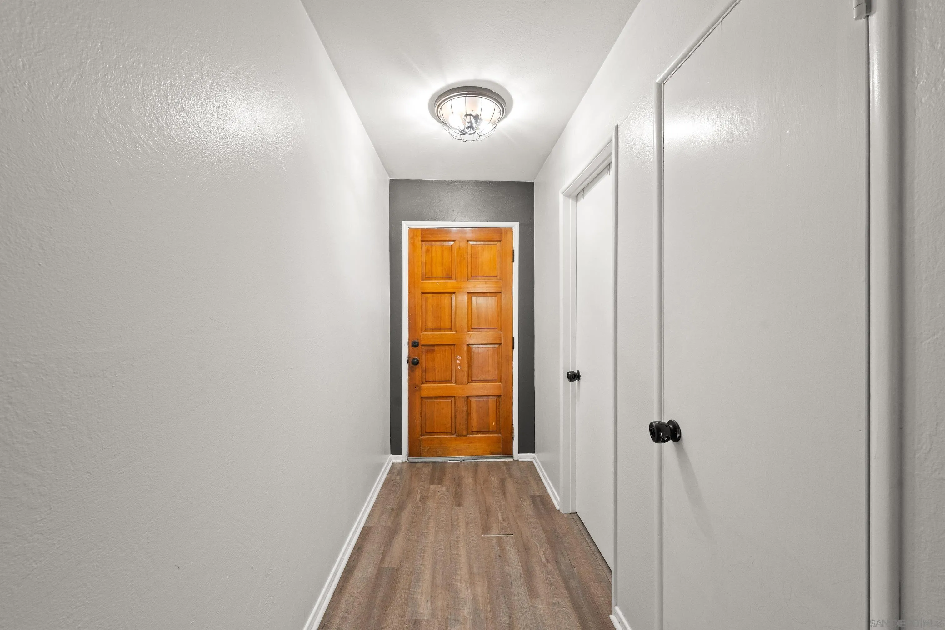 6656 Cathy Place Riverside, CA 92504 - Photo 11 of 49 a view of a hallway with wooden floor and closet