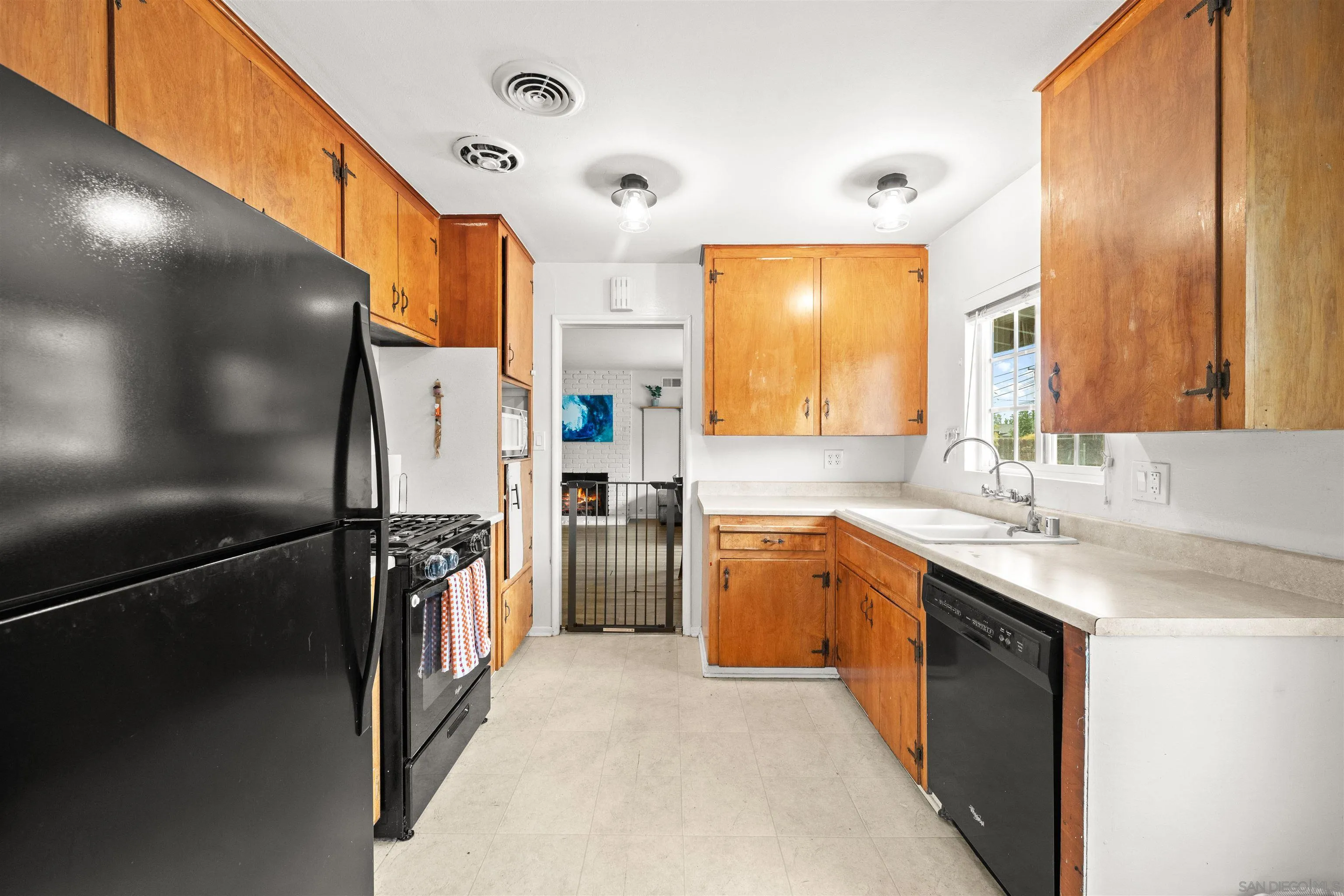 6656 Cathy Place Riverside, CA 92504 - Photo 20 of 49 a kitchen with stainless steel appliances granite countertop a refrigerator a sink a stove and island