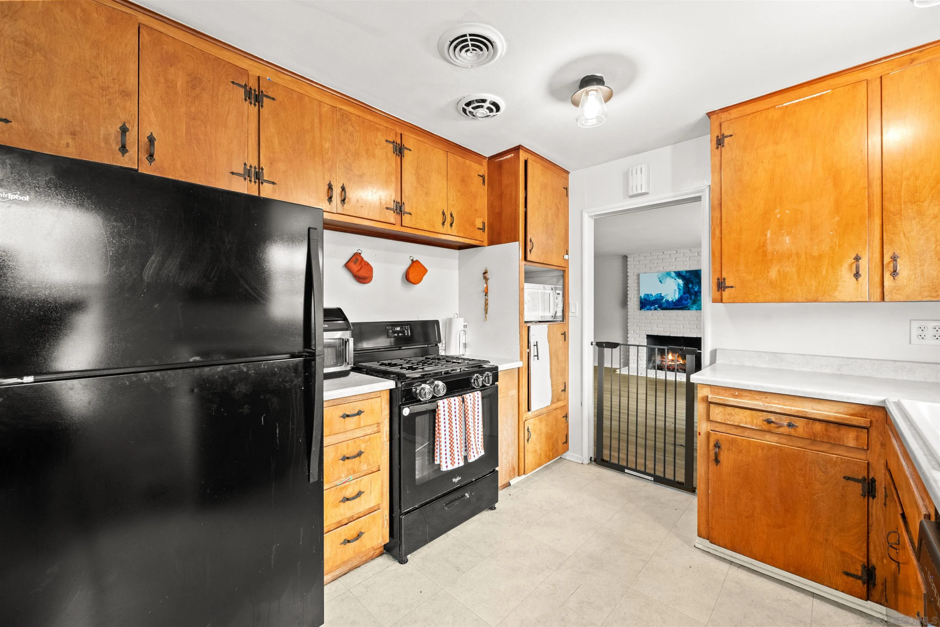 6656 Cathy Place Riverside, CA 92504 - Photo 21 of 49 a kitchen with stainless steel appliances granite countertop a refrigerator a stove and a sink
