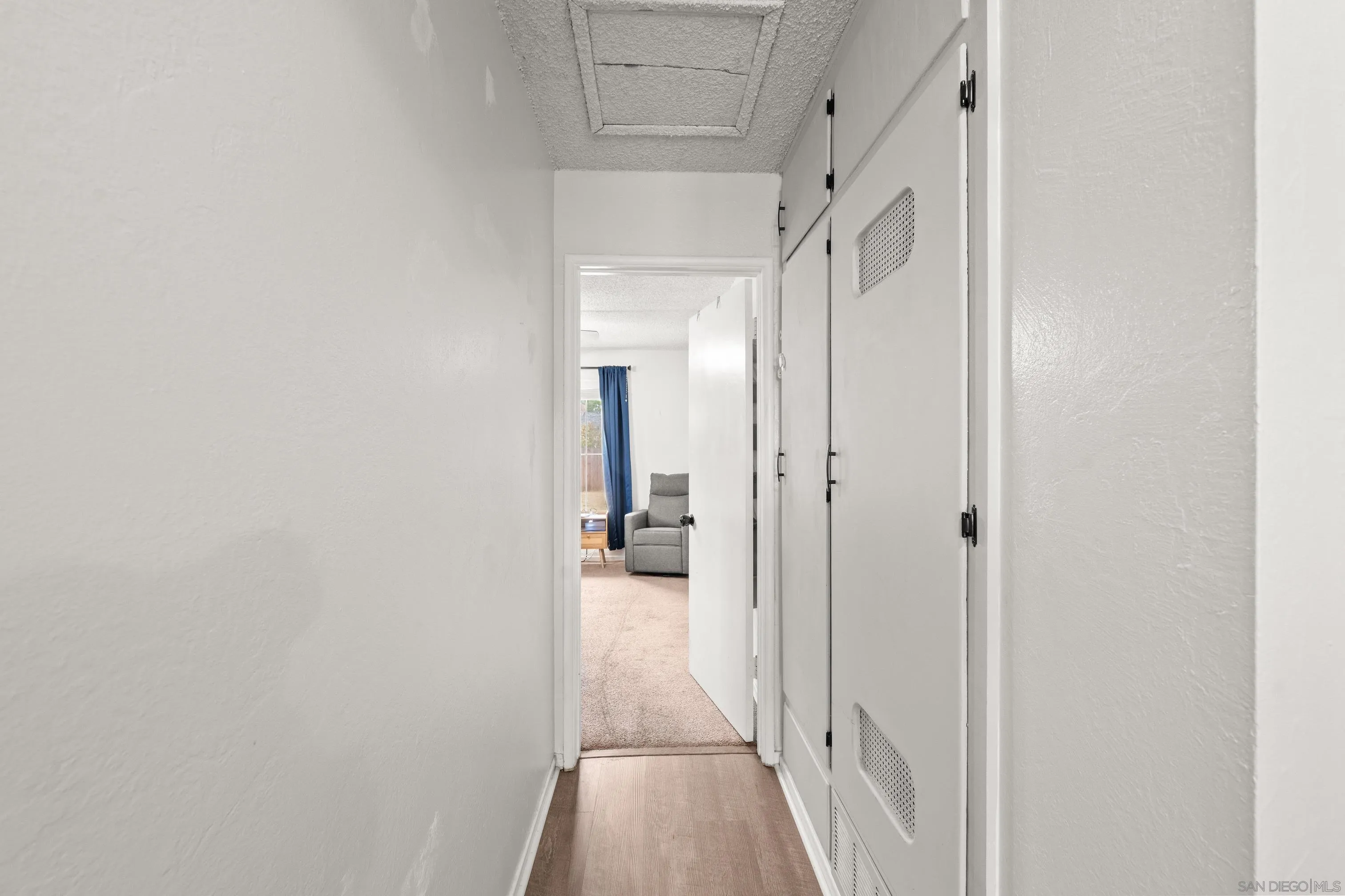 6656 Cathy Place Riverside, CA 92504 - Photo 35 of 49 a view of a hallway with a white walls and stairs