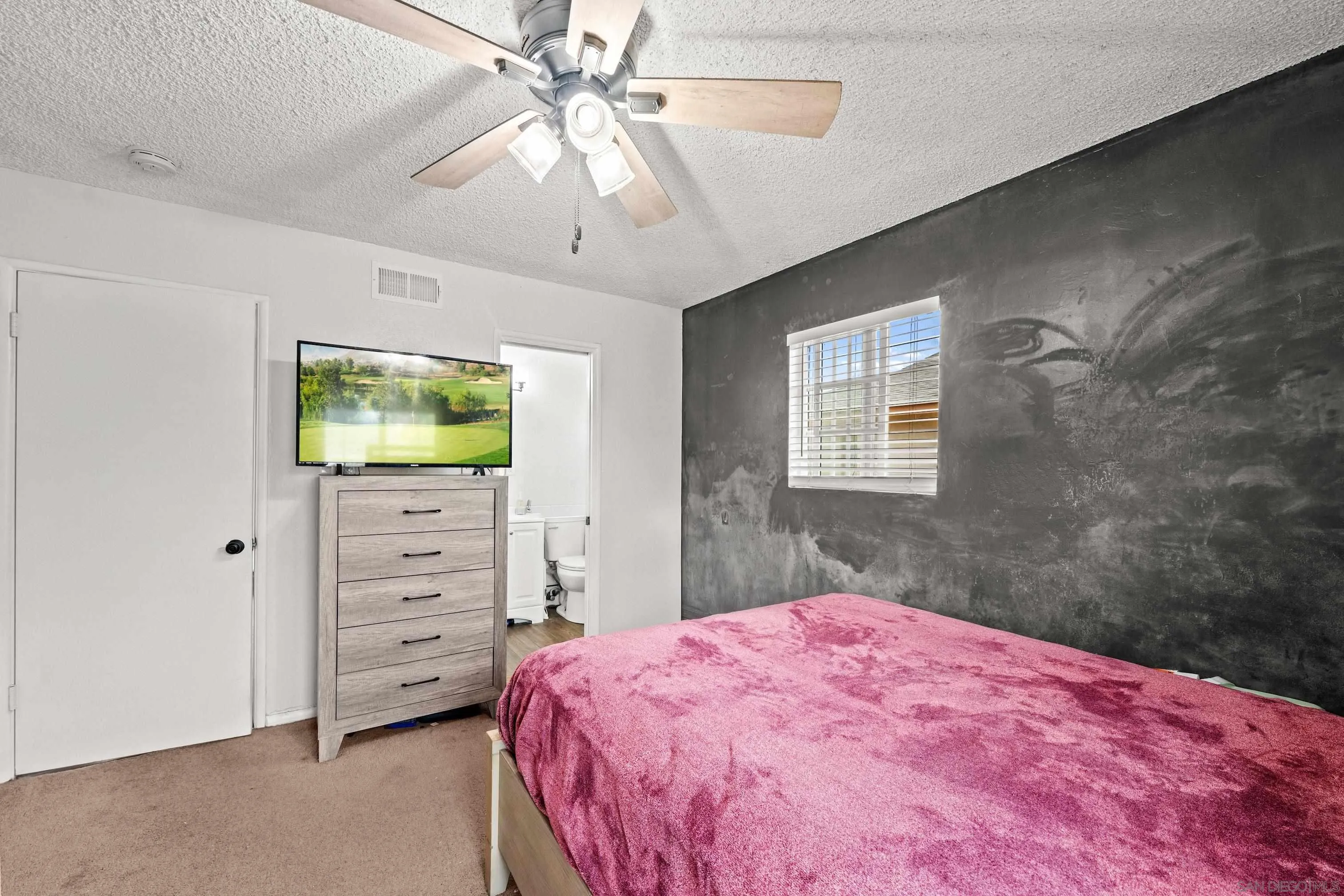 6656 Cathy Place Riverside, CA 92504 - Photo 37 of 49 a bedroom with a bed and a flat screen tv