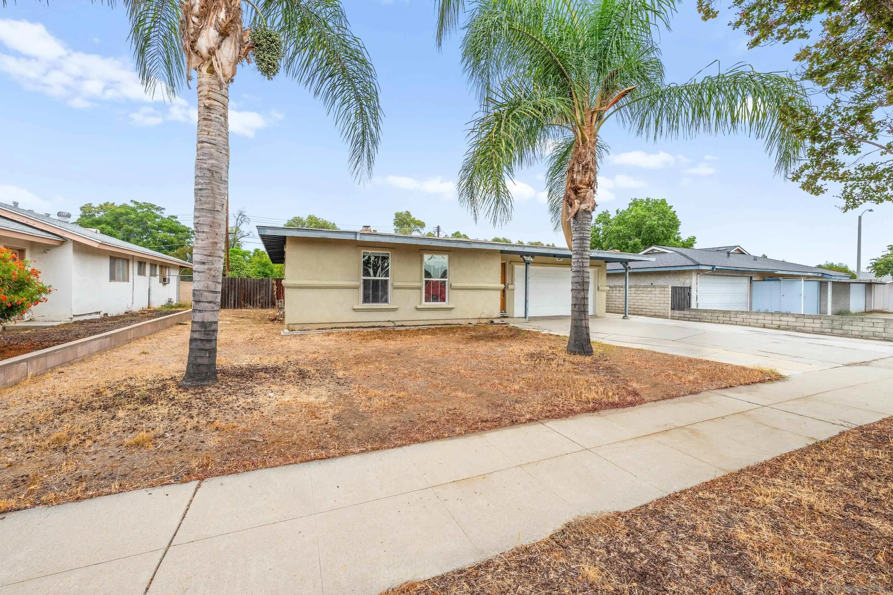 6656 Cathy Place Riverside, CA 92504 - Photo 6 of 49 a house with palm tree in front of it