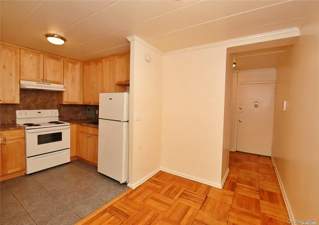 a kitchen with white cabinets and white appliances