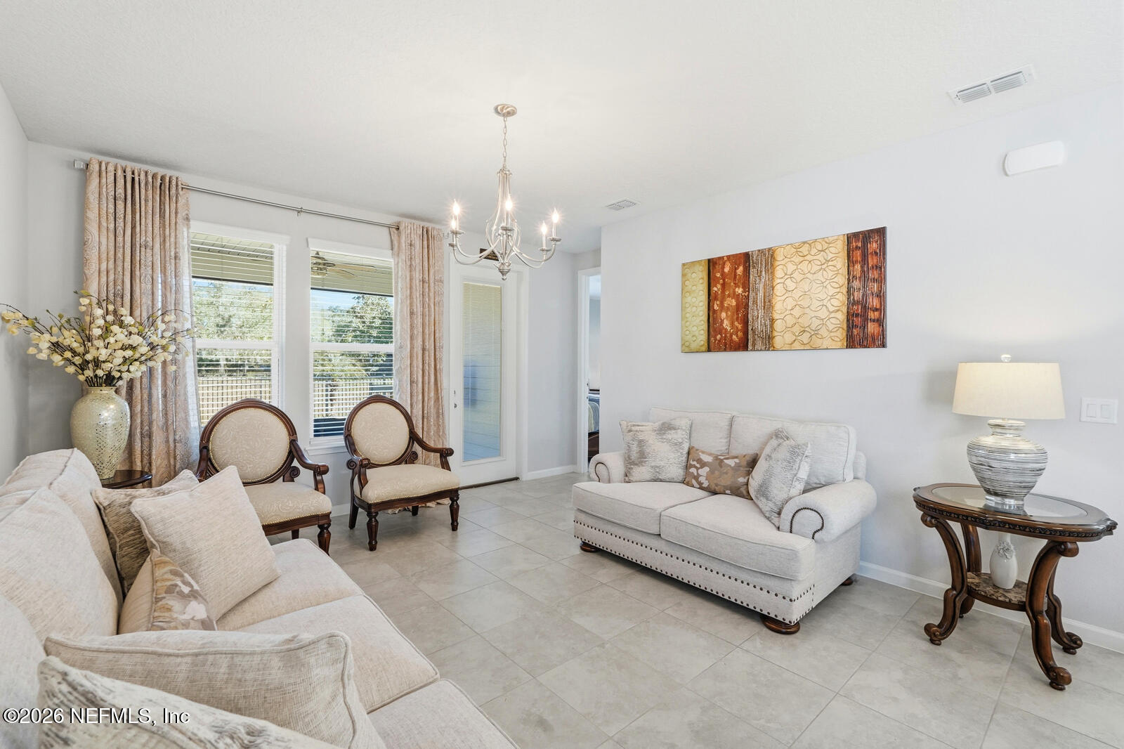 979 Rustic Ml Drive St. Augustine, FL 32092 - Photo 13 of 46 a living room with furniture and a chandelier
