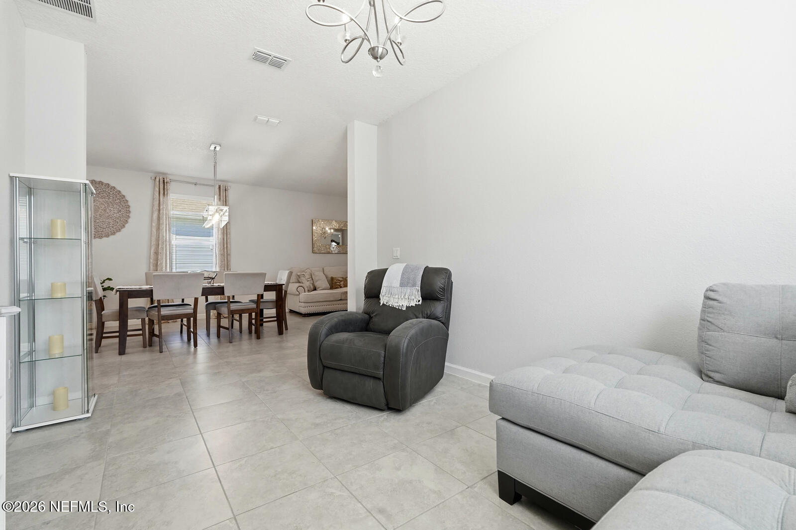 979 Rustic Ml Drive St. Augustine, FL 32092 - Photo 16 of 46 a living room with furniture and a chandelier
