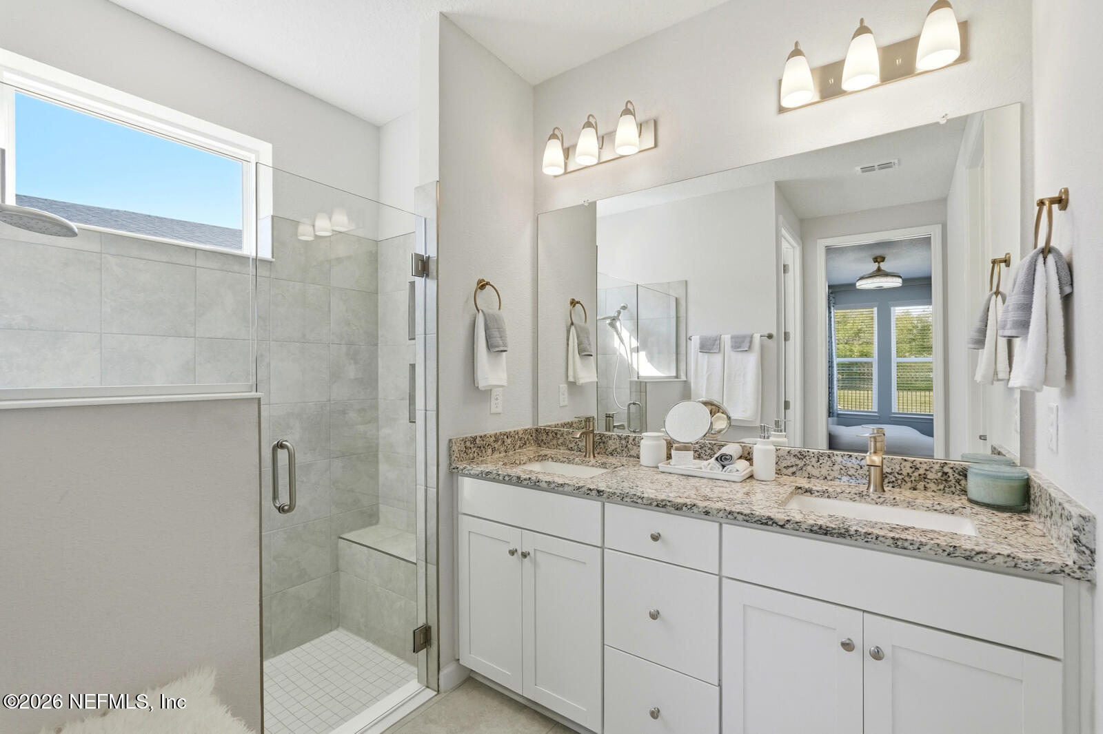 979 Rustic Ml Drive St. Augustine, FL 32092 - Photo 19 of 46 a bathroom with a granite countertop sink a toilet and shower