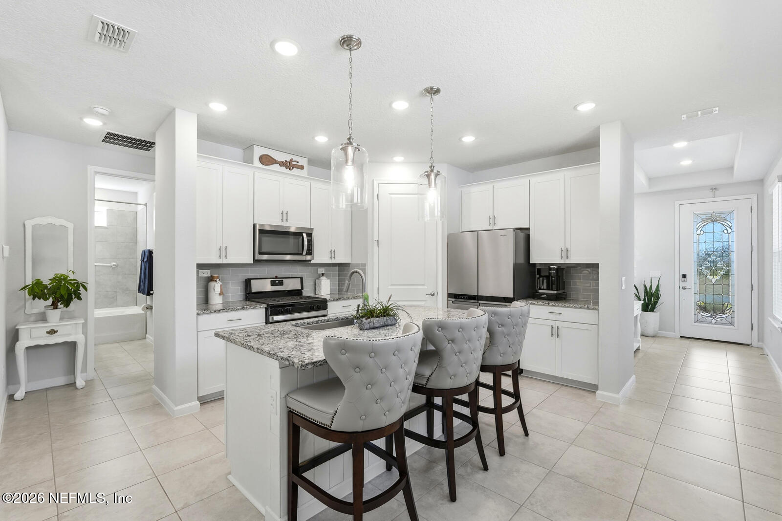 979 Rustic Ml Drive St. Augustine, FL 32092 - Photo 8 of 46 a kitchen with stainless steel appliances kitchen island granite countertop a sink and cabinets