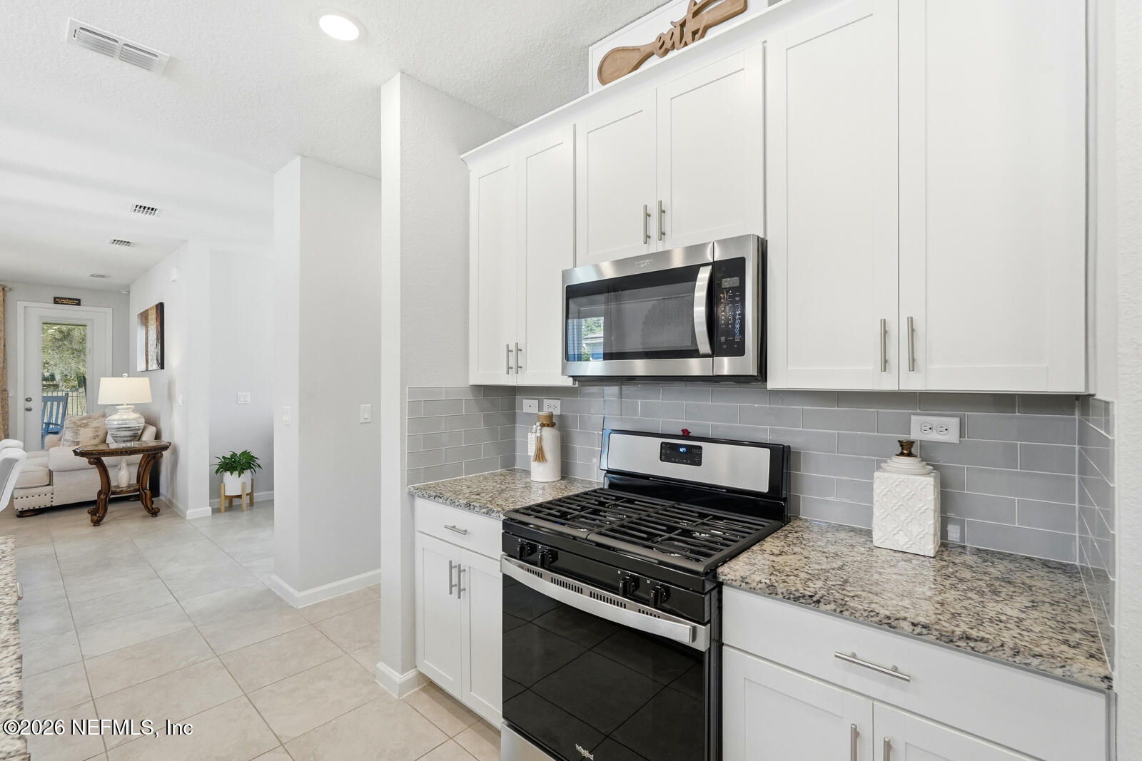 979 Rustic Ml Drive St. Augustine, FL 32092 - Photo 9 of 46 a kitchen with stainless steel appliances a sink dishwasher stove microwave and cabinets