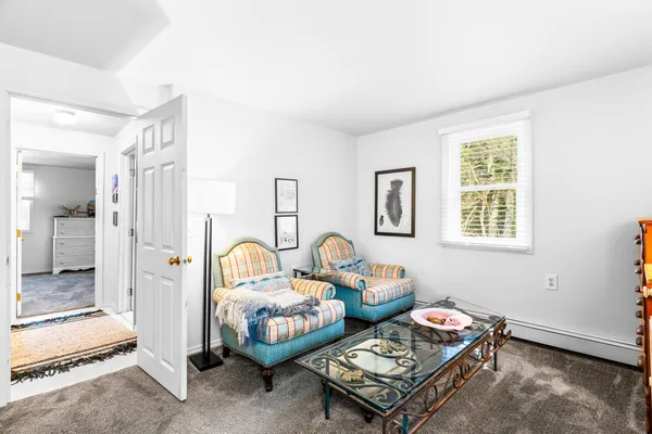 a bedroom with furniture and a window