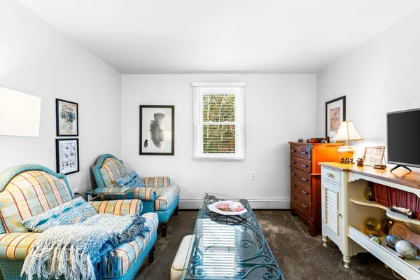 a bedroom with furniture and a window