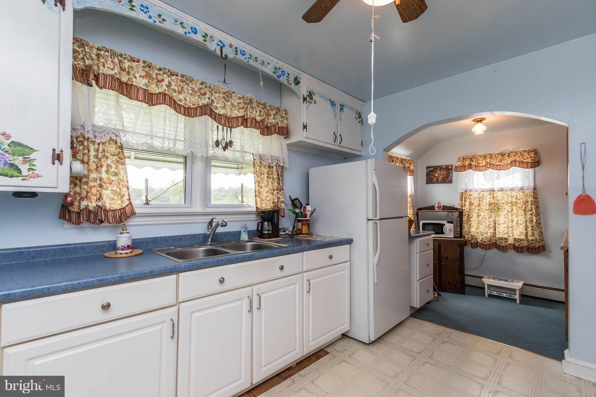 1609 Ridge Road Westminster, MD 21157 - Photo 8 of 28 a kitchen with stainless steel appliances kitchen island granite countertop a table and chairs in it