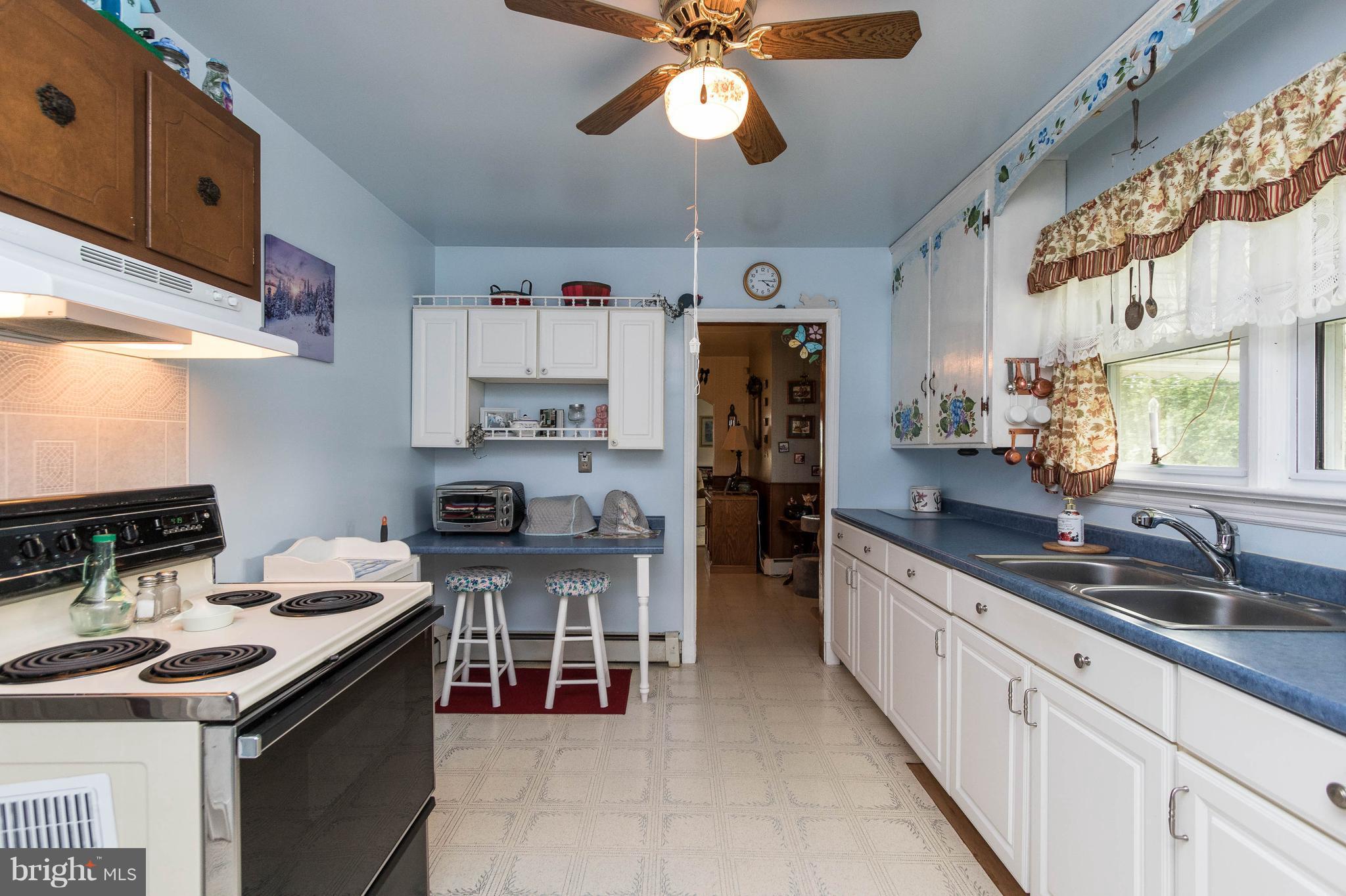 1609 Ridge Road Westminster, MD 21157 - Photo 10 of 28 a kitchen with stainless steel appliances granite countertop a sink stove and refrigerator
