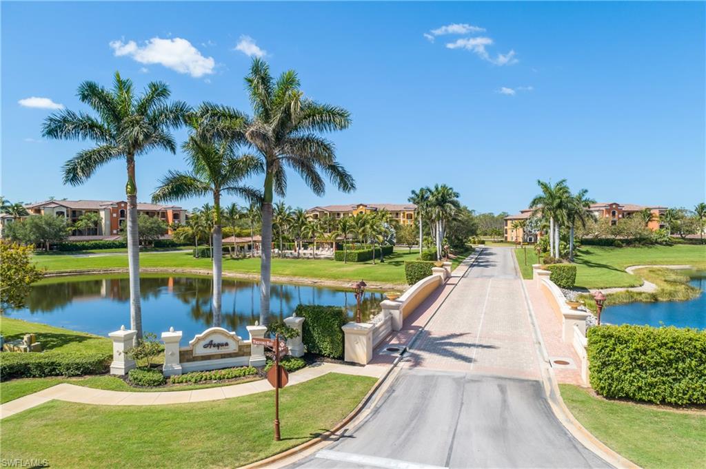 9719 Acqua Court, Unit 214 Naples, FL 34113 - Photo 32 of 50 a view of a lake with couches and wooden fence
