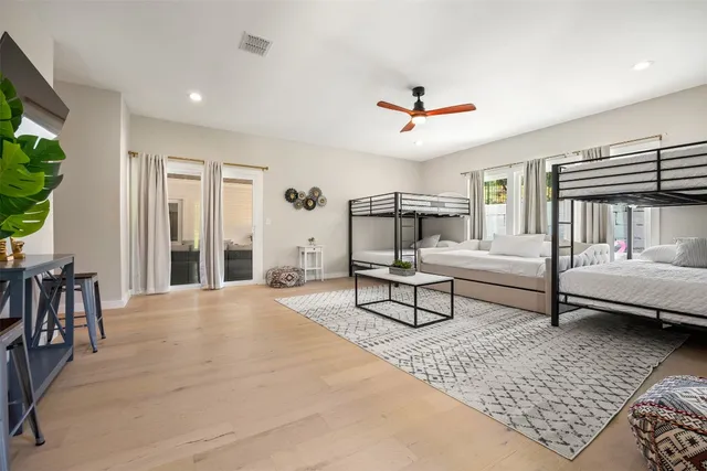 a bedroom with furniture and a large window