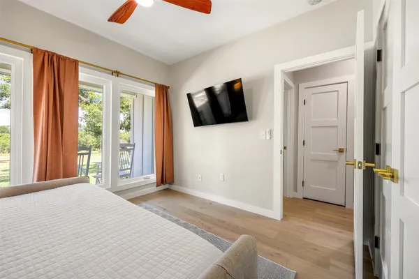 a bedroom with a bed and flat screen tv