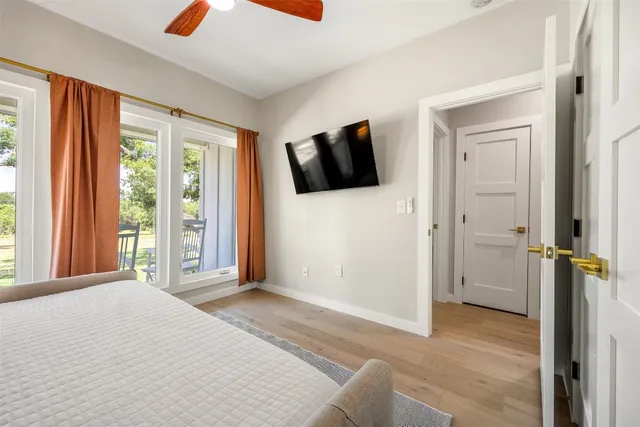 a bedroom with a bed and flat screen tv