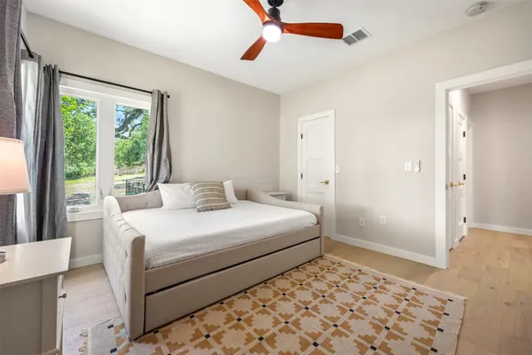 a bedroom with a bed and a window