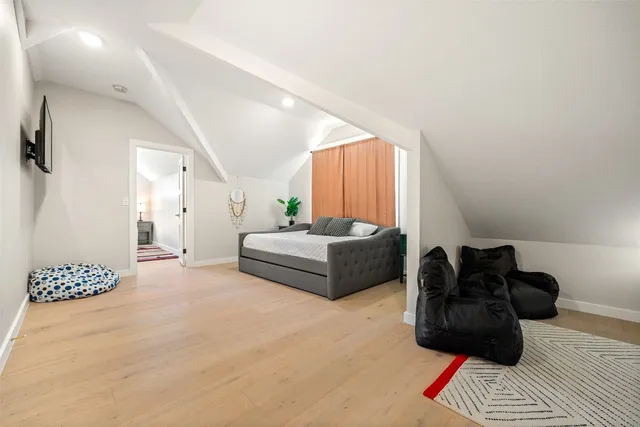 a bedroom with furniture and wooden floor