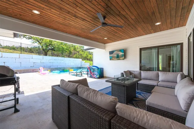 a living room with furniture a floor to ceiling window and a table
