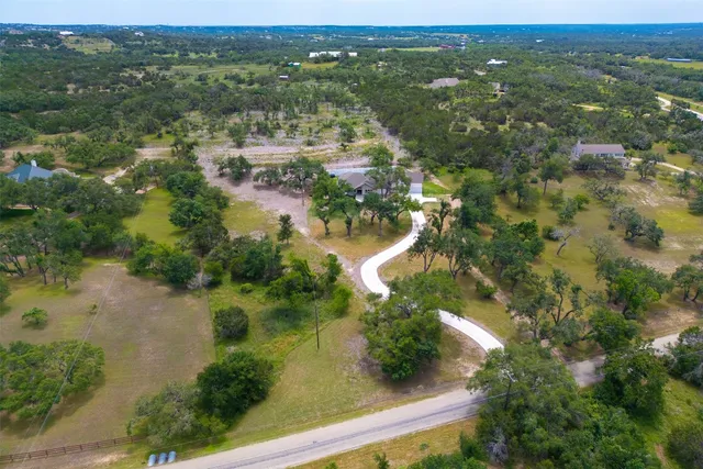 an aerial view of a house with a yard