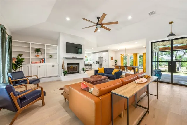 a living room with furniture a flat screen tv and a fireplace