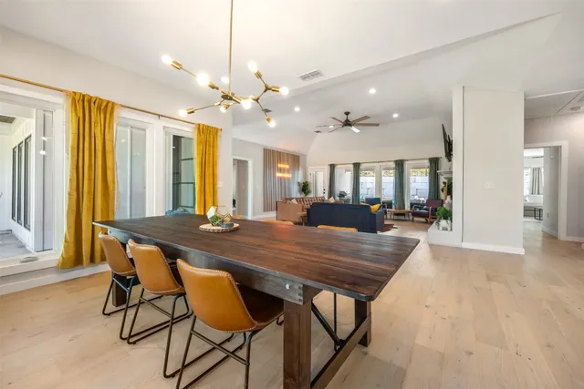 a view of a dining room with furniture and a chandelier