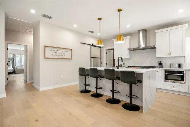 a kitchen with stainless steel appliances kitchen island granite countertop a table and chairs in it