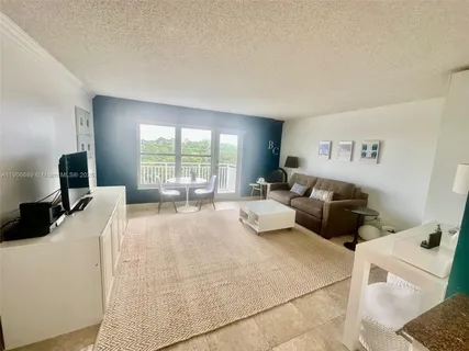 a large bedroom with a bed and large window