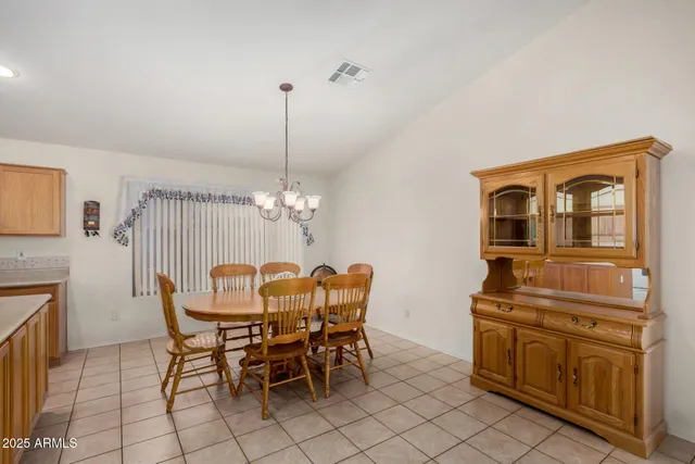 a dining room with furniture a chandelier and wooden floor