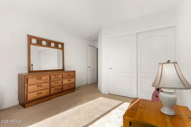 a bedroom with a bed and a dresser