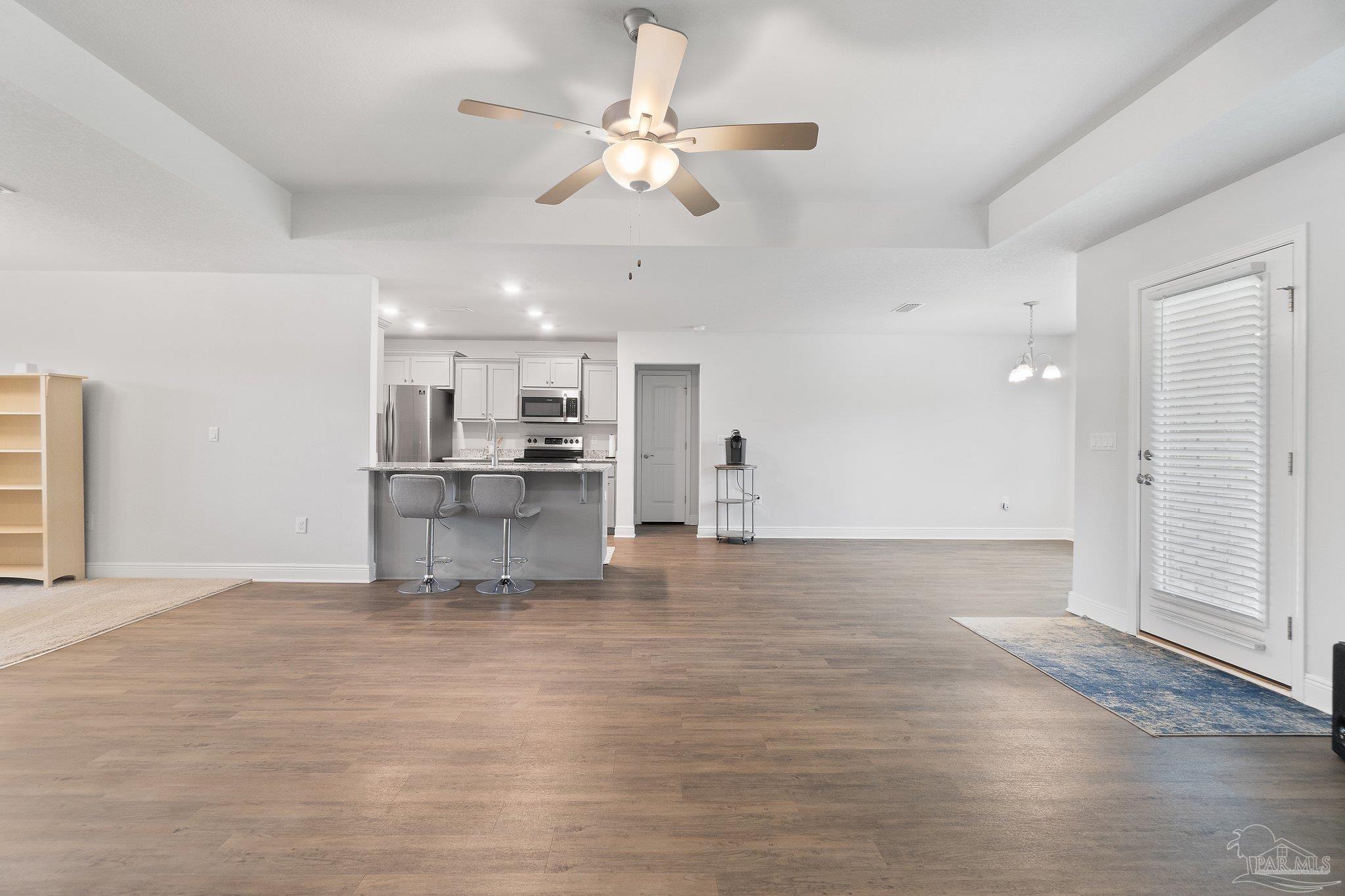 1463 Promenade Loop Cantonment, FL 32533 - Photo 12 of 41 a view of a kitchen with a sink hardwood floor and a kitchen view