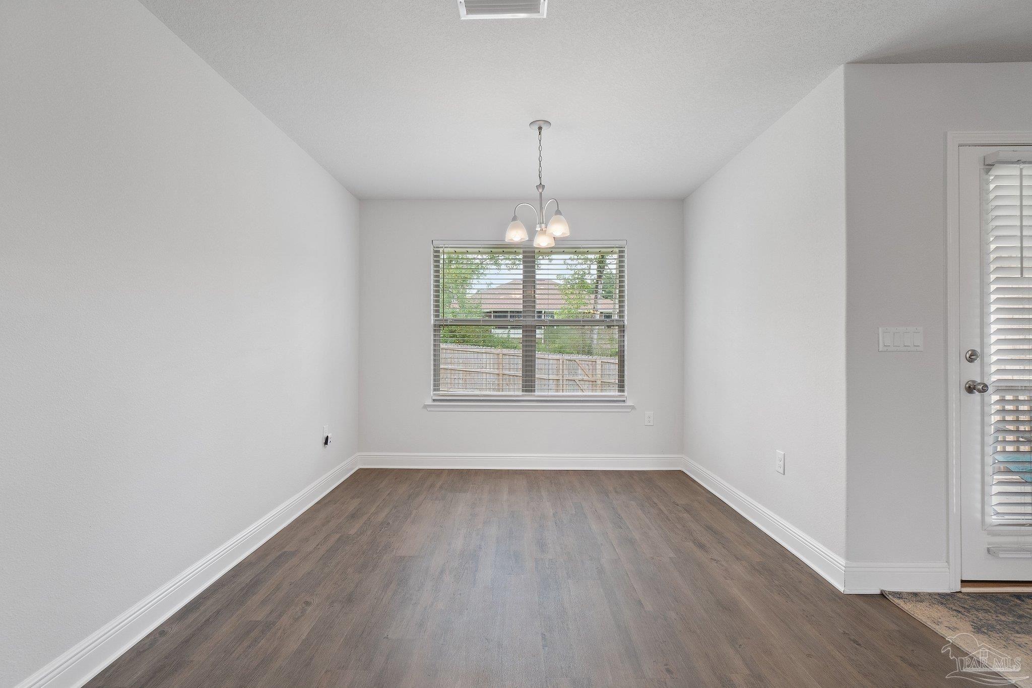 1463 Promenade Loop Cantonment, FL 32533 - Photo 13 of 41 an empty room with wooden floor and windows