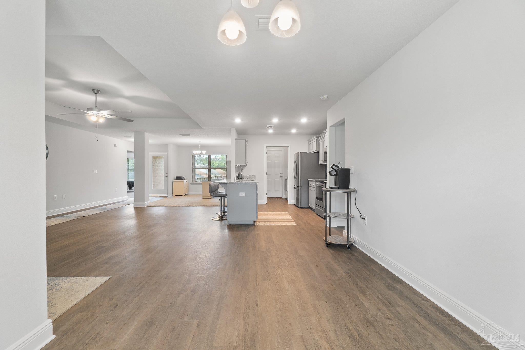 1463 Promenade Loop Cantonment, FL 32533 - Photo 14 of 41 a view of a living room hardwood floor and a kitchen