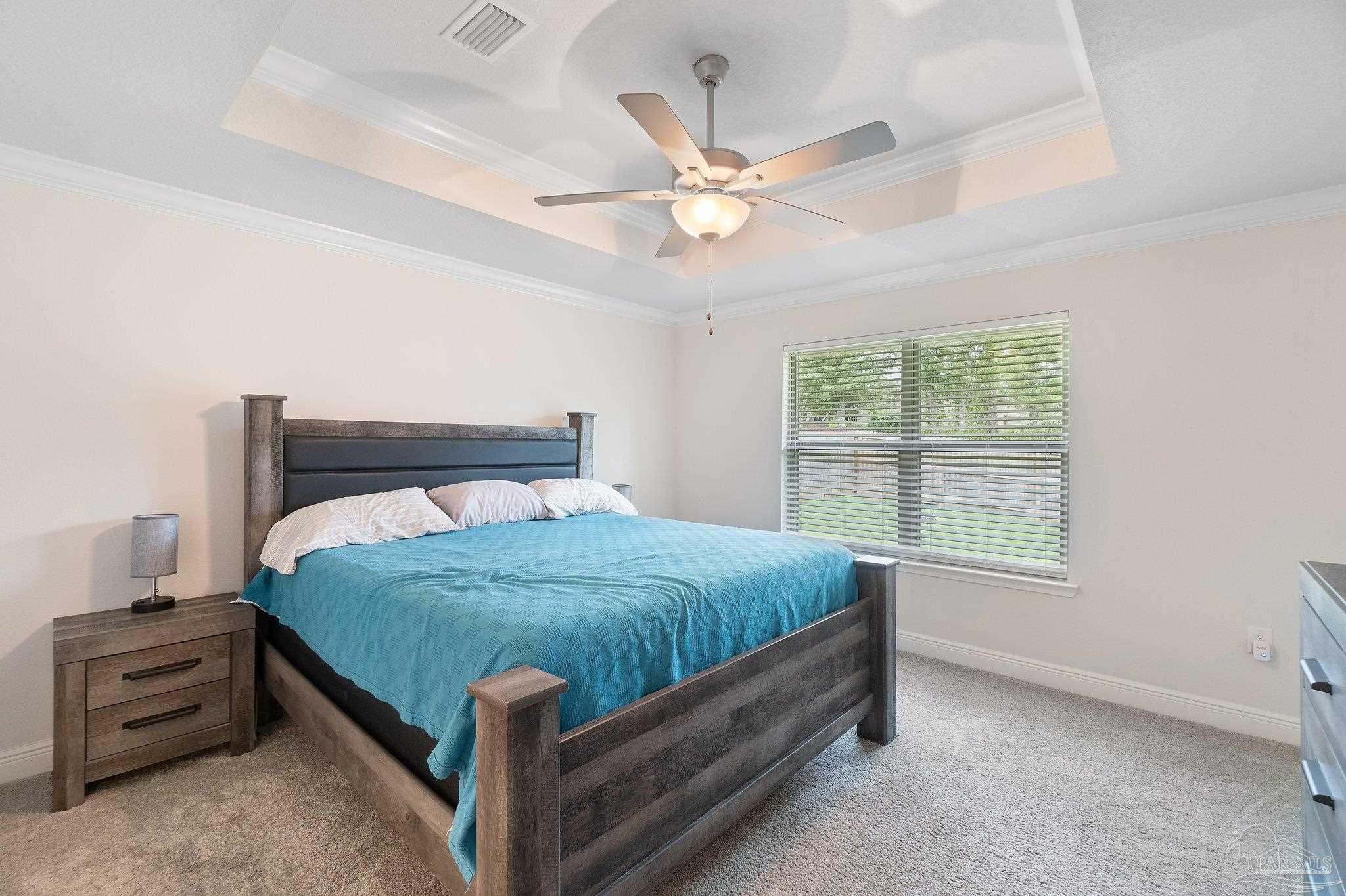 1463 Promenade Loop Cantonment, FL 32533 - Photo 20 of 41 a bed sitting in a bedroom next to a window