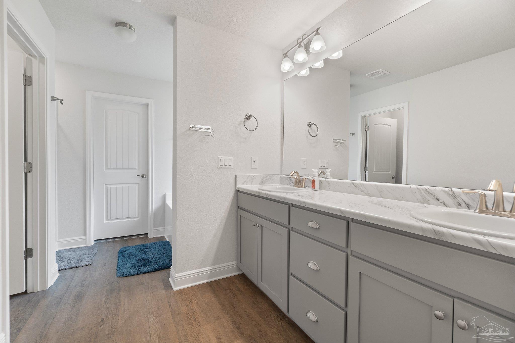 1463 Promenade Loop Cantonment, FL 32533 - Photo 24 of 41 a spacious bathroom with a double vanity sink a mirror and shower